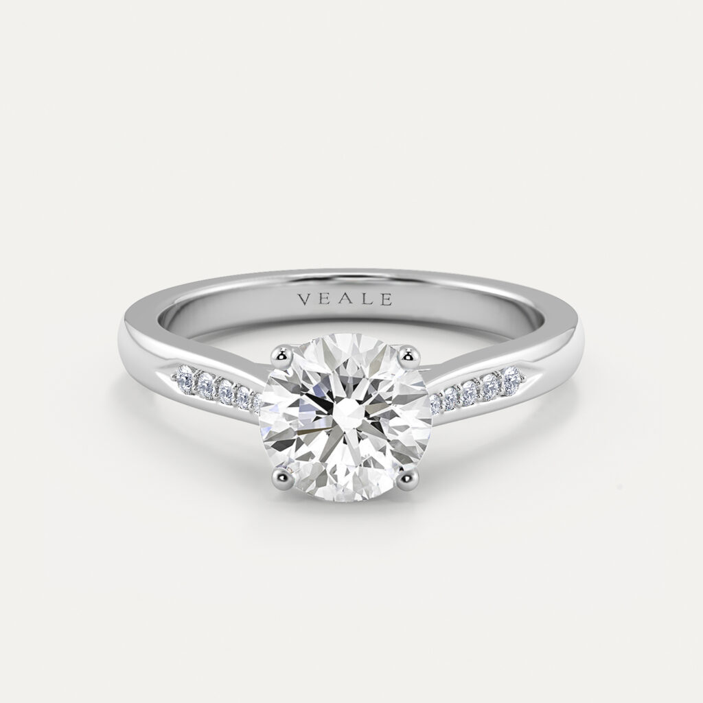 Round brilliant diamond engagement ring with diamond set shoulders