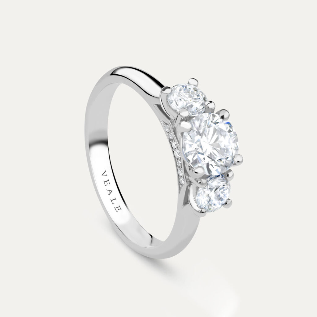 Round brilliant trilogy engagement ring side view