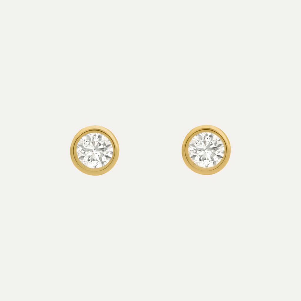 Bezel-set diamond earrings crafted in yellow gold, offering a classic and elegant accessory choice.
