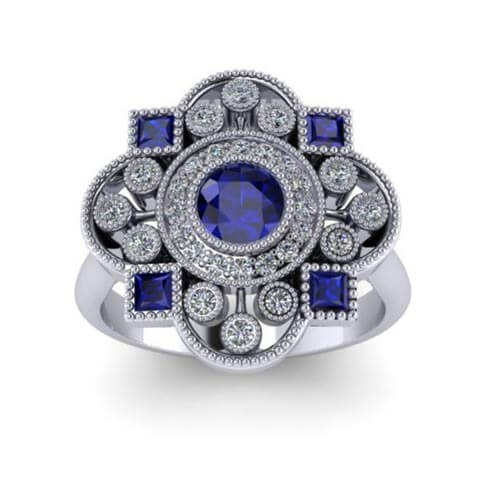 Design of a Vintage-inspired engagement ring featuring princess-cut Ceylon sapphires and round diamonds, accentuated by an round cut sapphire surrounded by a halo of diamonds, all expertly crafted in platinum for a timeless and exquisite design.