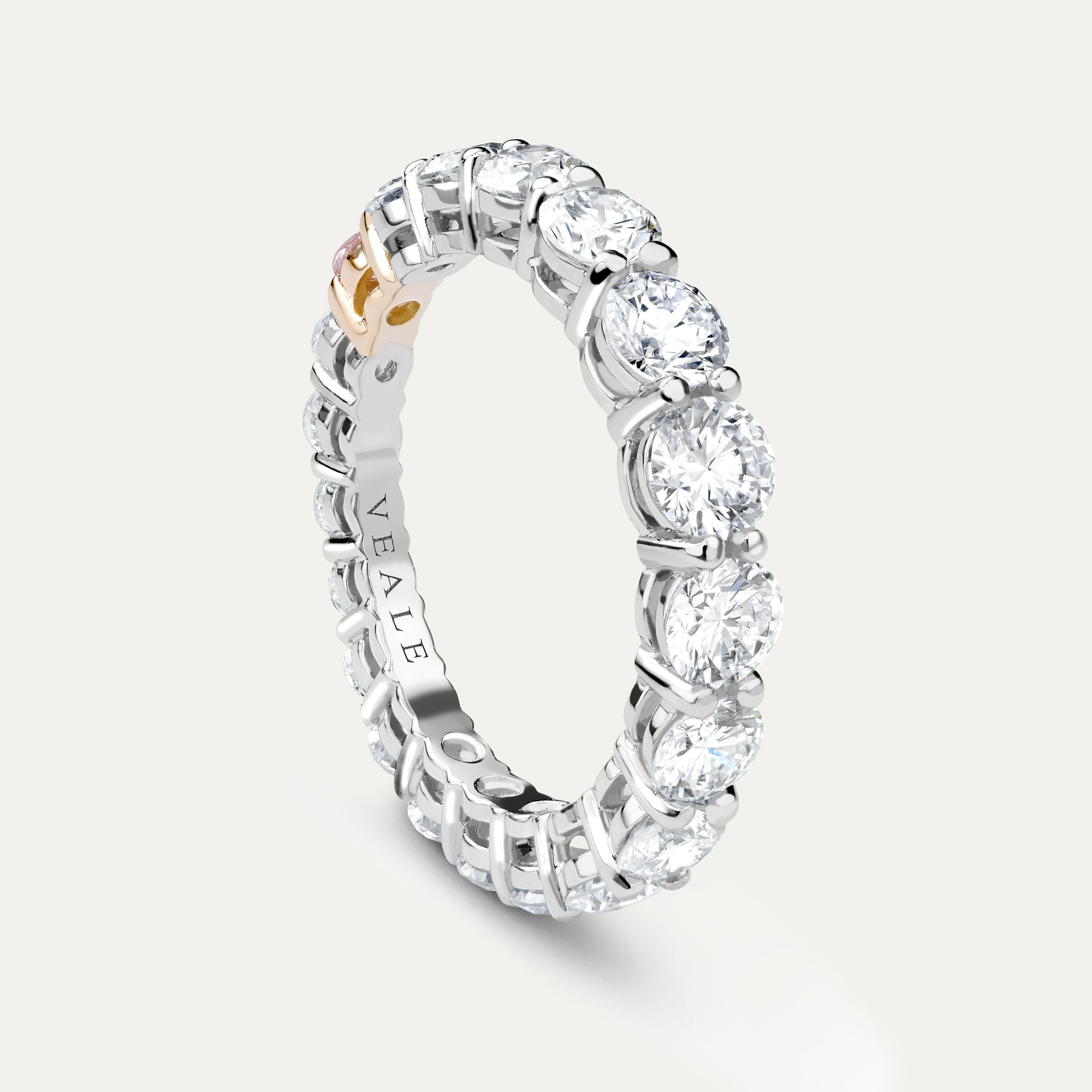 Eternity ring with pink diamond