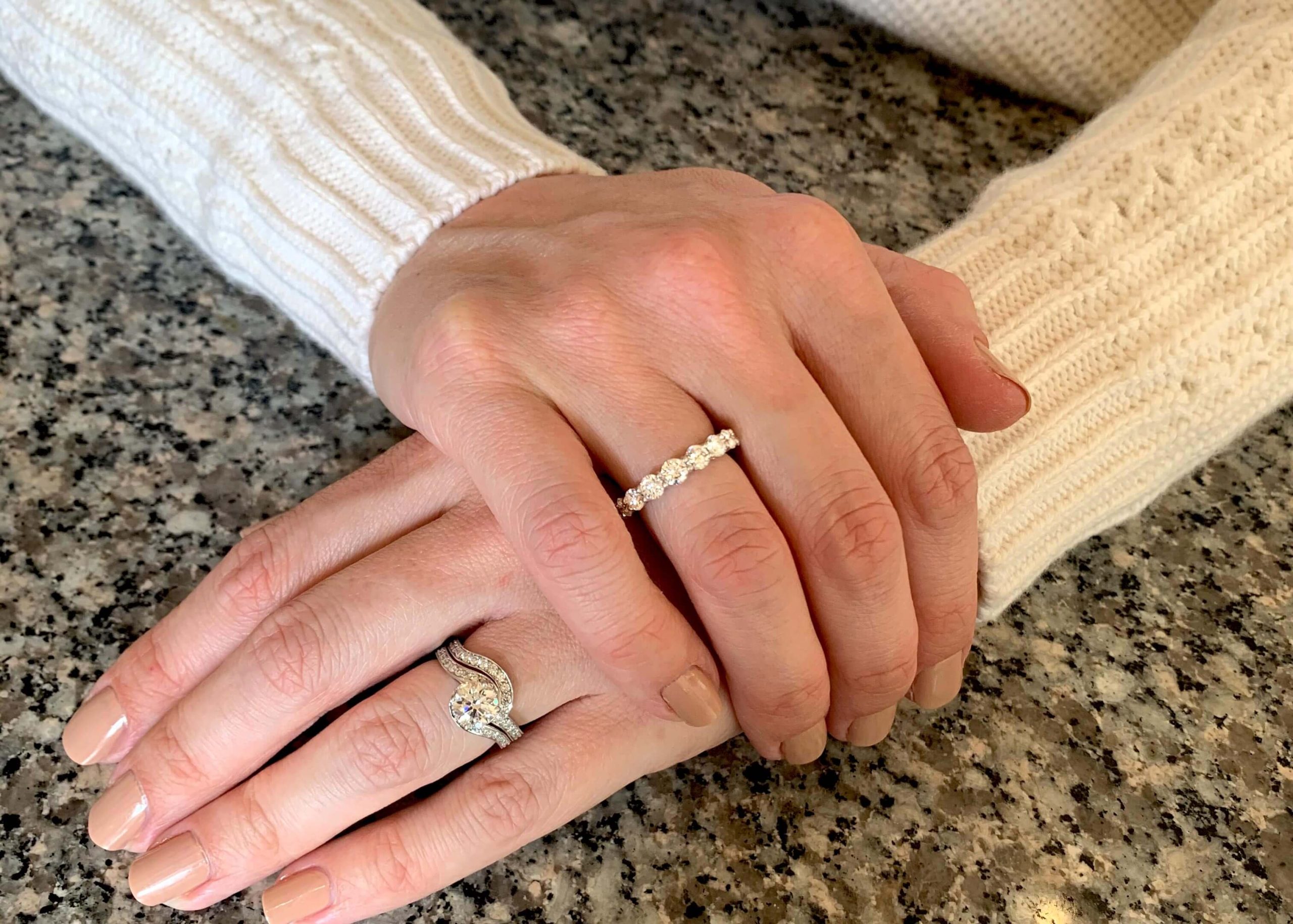 Hands with eternity ring as well as engagement and wedding ring
