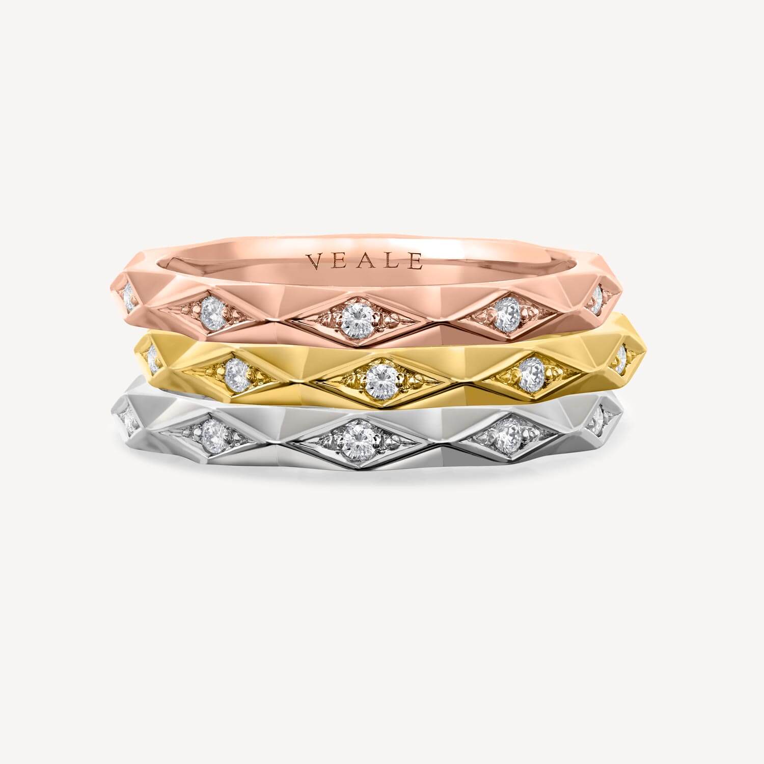 3 Geometric stacking rings in Rose gold, yellow gold and platinum all made by Veale fine jewellery in London