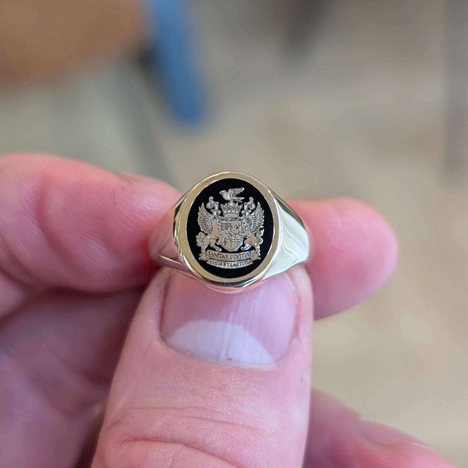 Gold signet ring with family engraving and black enamel made during a period of high gold prices