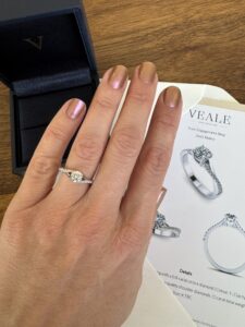 Engagement ring on hand next to the engagement ring design